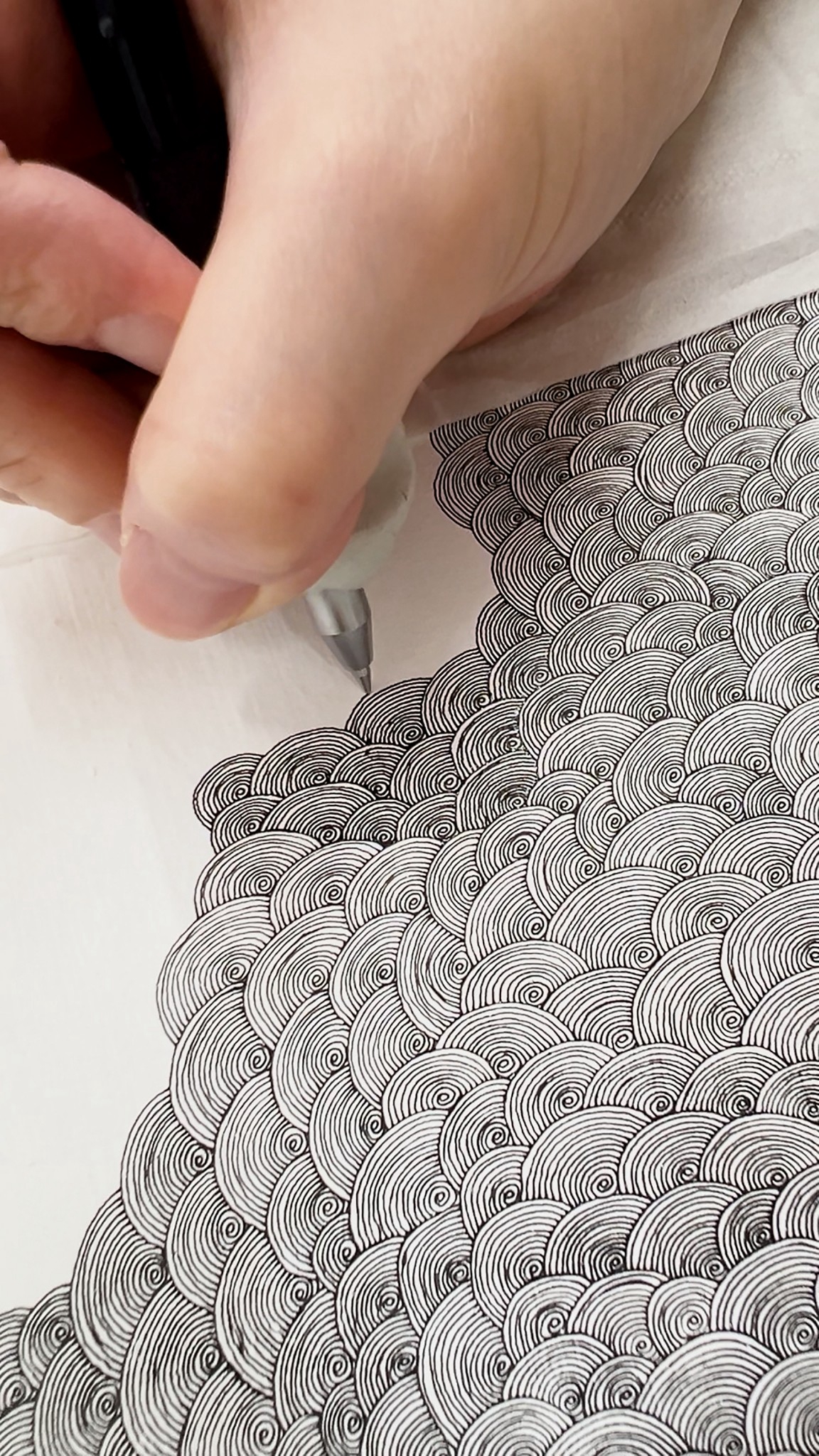 ペンで渦を描き重ねるdon氏の手元